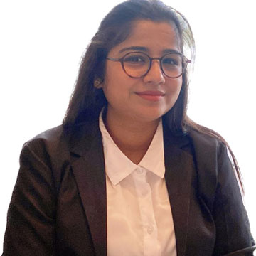 A woman wearing glasses and a business suit.